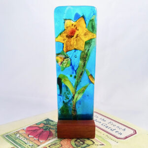 Fused Glass Sculpturette Sunrise Daffodil - atop a book