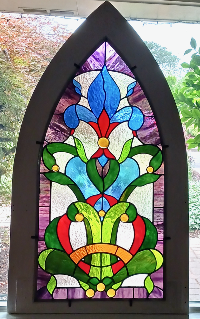 Fleur de Lys - stained glass window installed in gothic arch frame